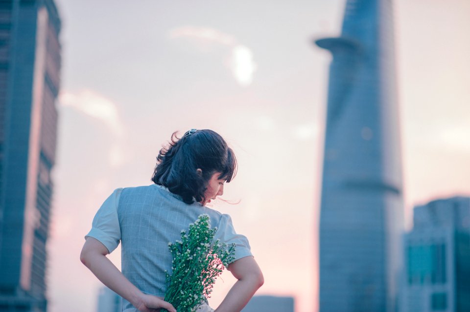 Selective Focus Photo Of Woman Holding White Flower photo