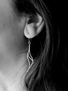 Grayscale Photo Of Womans Hook Earrings photo