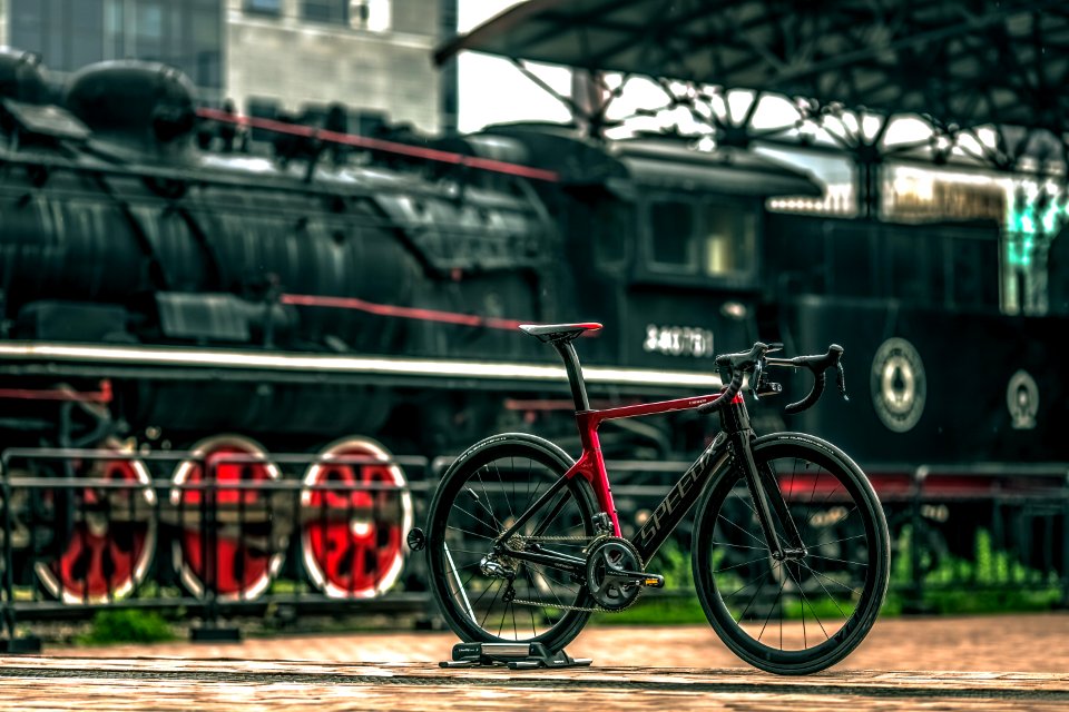 Black And Red Road Bike Near Black Train