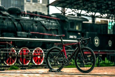 Black And Red Road Bike Near Black Train photo