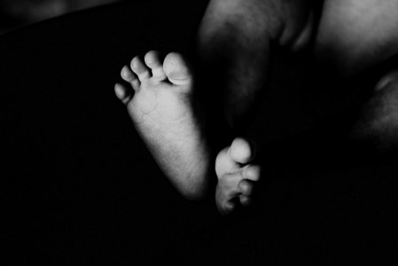 Grayscale Photography Of Babys Feet photo