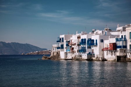 Photo Of White Concrete Buildings Near Body Of Water photo