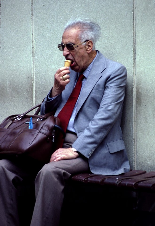 Man In Grey Suit Eating Ice Cream