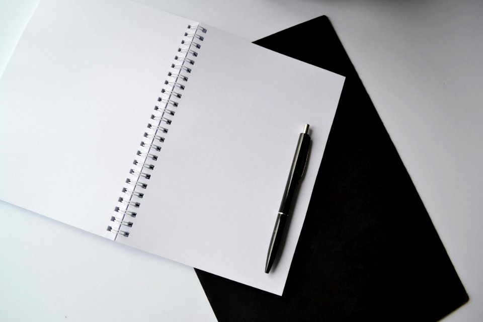 Black Click Pen On Spiral Notebook