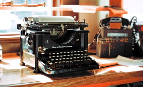 Classic Black Typewriter On Brown Wooden Desk photo