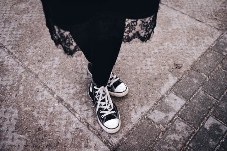 Persons Feet Wearing Black-and-white High-top Sneakers photo