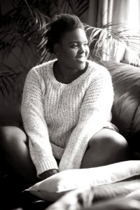 Woman Wearing Sweater Sitting On The Sofa photo