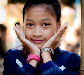 Girl Wearing Blue Long-sleeved Top Resting Face On Hands photo