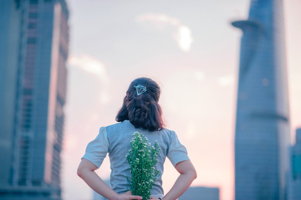 Photography Of Woman Holding White Flowers