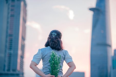 Photography Of Woman Holding White Flowers photo