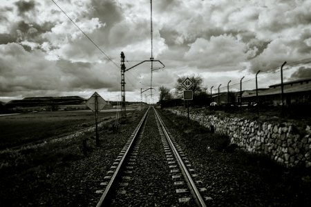 Grayscale Photograph Of Train Rail photo