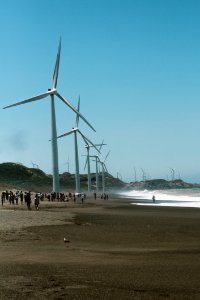 Wind Mills Near The Body Of Water