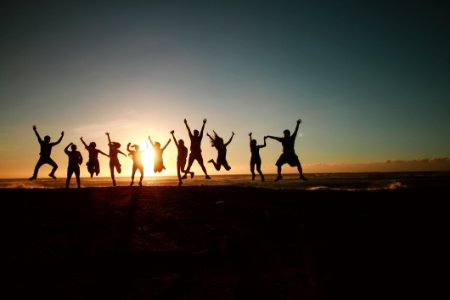 Silhouette Photography Of Group Of People Jumping During Golden Time photo