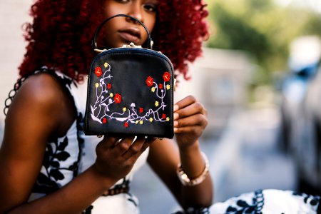 Woman Holding Black Leather Handbag