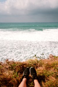 Person Wearing Pair Of Black Running Shoes Near Body Of Water photo