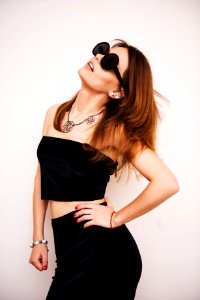 Woman Wearing Black Crop Top Standing Under White Background