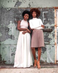 Two Women Standing Beside Wall At Daytime photo