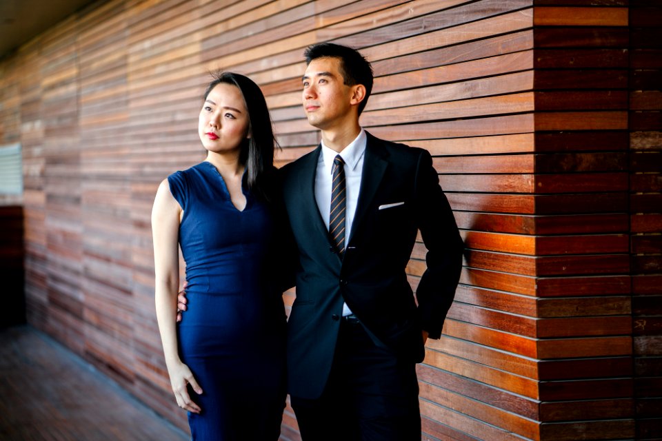 Models Posing An And Woman Standing Next To Each Other Looking Upward photo