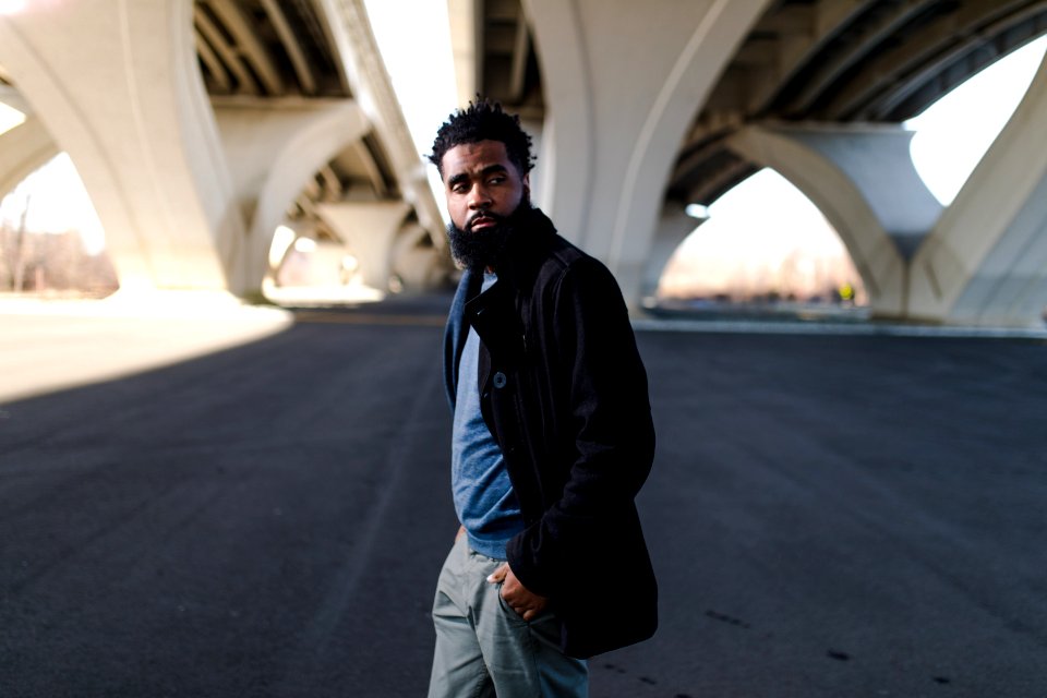 Man Wearing Black Long Jacket And Blue Shirt Holding Pocket