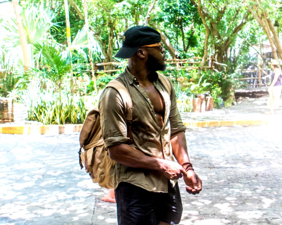 Man Wearing Hat And Backpack
