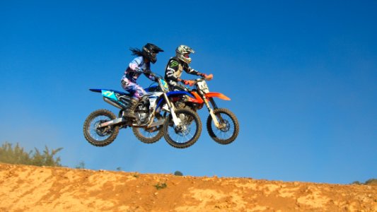 Two Person Riding Motocross Dirt Bikes photo