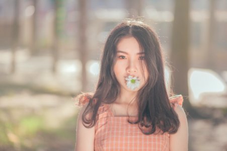 Photo Of Woman With Flower On Her Mouth photo