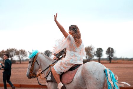 Woman Riding On White Horse