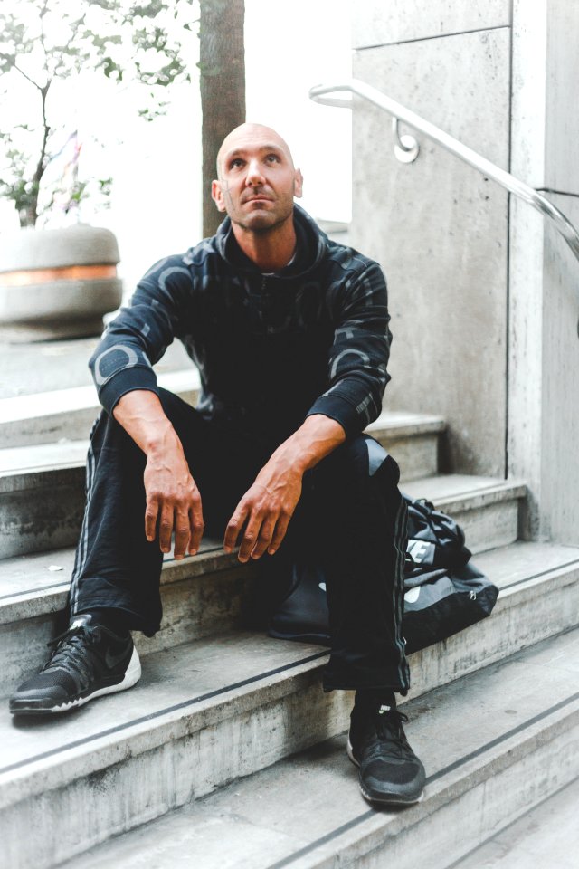 Man Sitting On Concrete Stair Looking Up