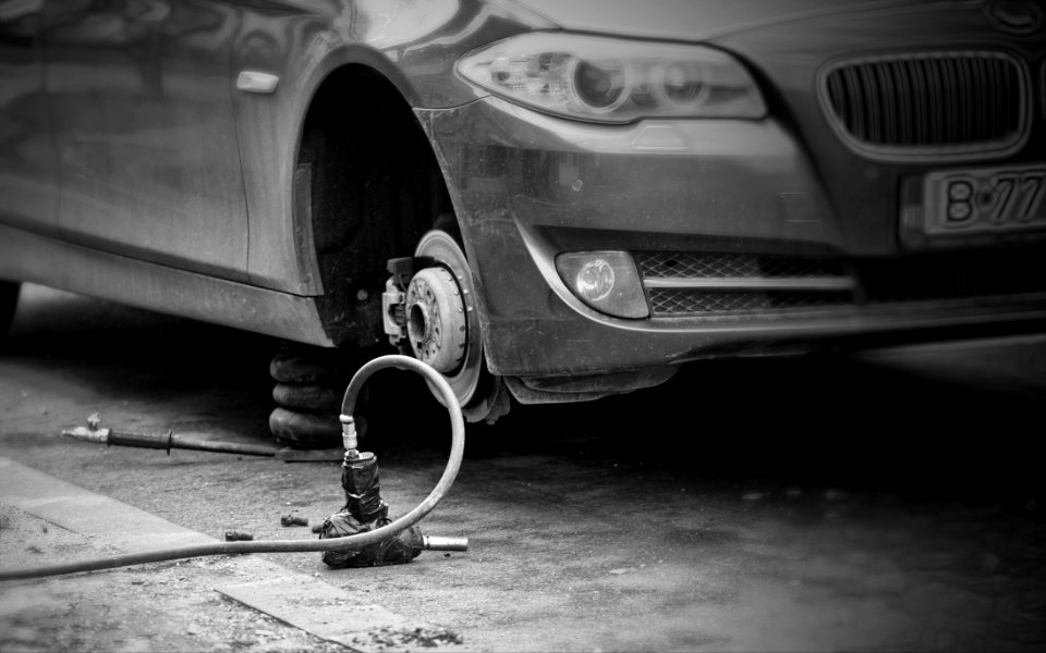 Grayscale Photo Of Car Without Wheel
