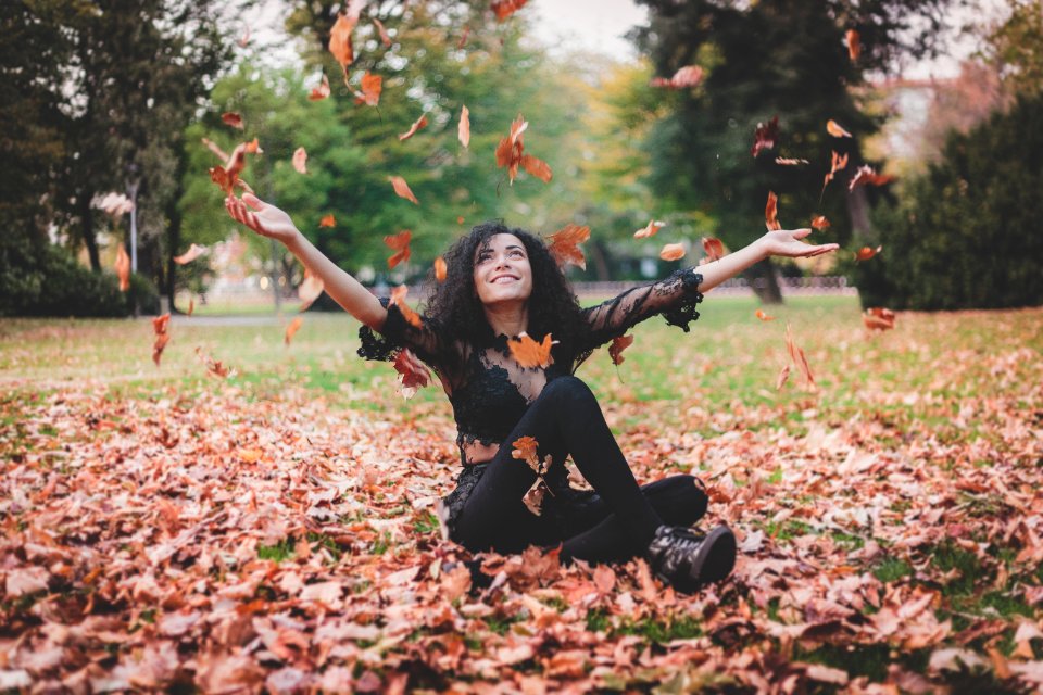 Woman Siting On Dried Leaves