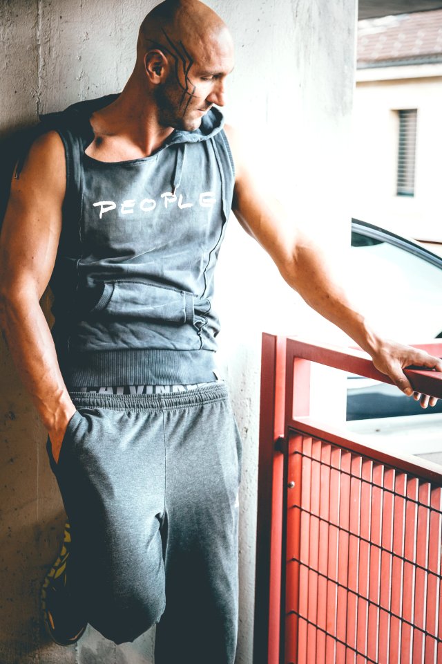 Man Wearing Grey Sleeveless Hoodie And Grey Sweatpants