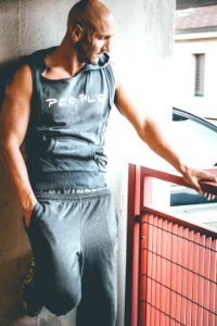 Man Wearing Grey Sleeveless Hoodie And Grey Sweatpants photo