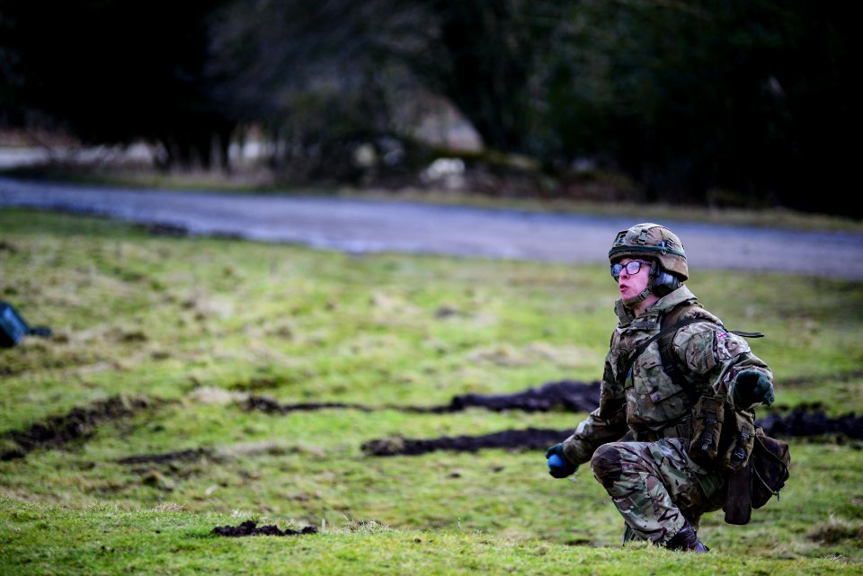 Man On Squat Position Standing On Grass