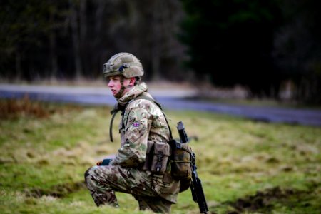 Soldier In Green And Brown Camouflage Uniform On Grass Field photo