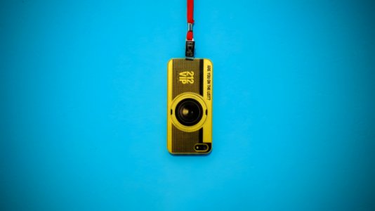 Yellow 212 Vip Camera Hanging On Blue Wall
