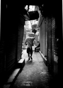 Grayscale Photo Of Man Carrying Sack photo