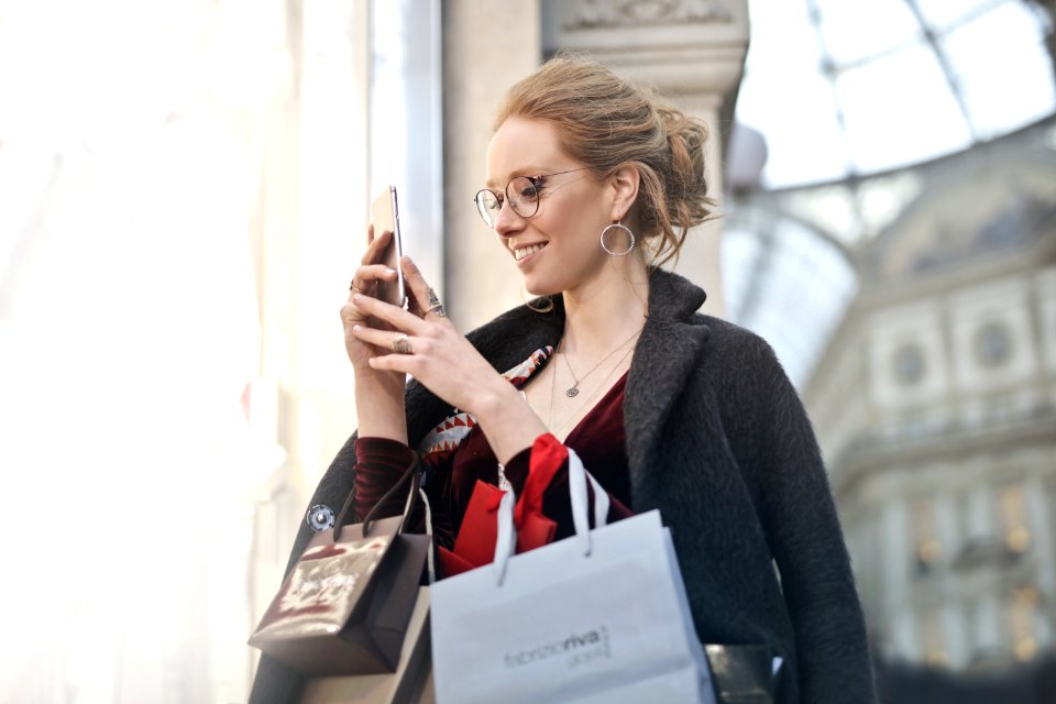 Woman Standing Near Wall Holding Phone