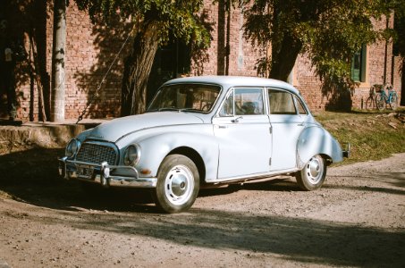 Classic Blue Sedan Near Green Leaf Trees At Daytime photo