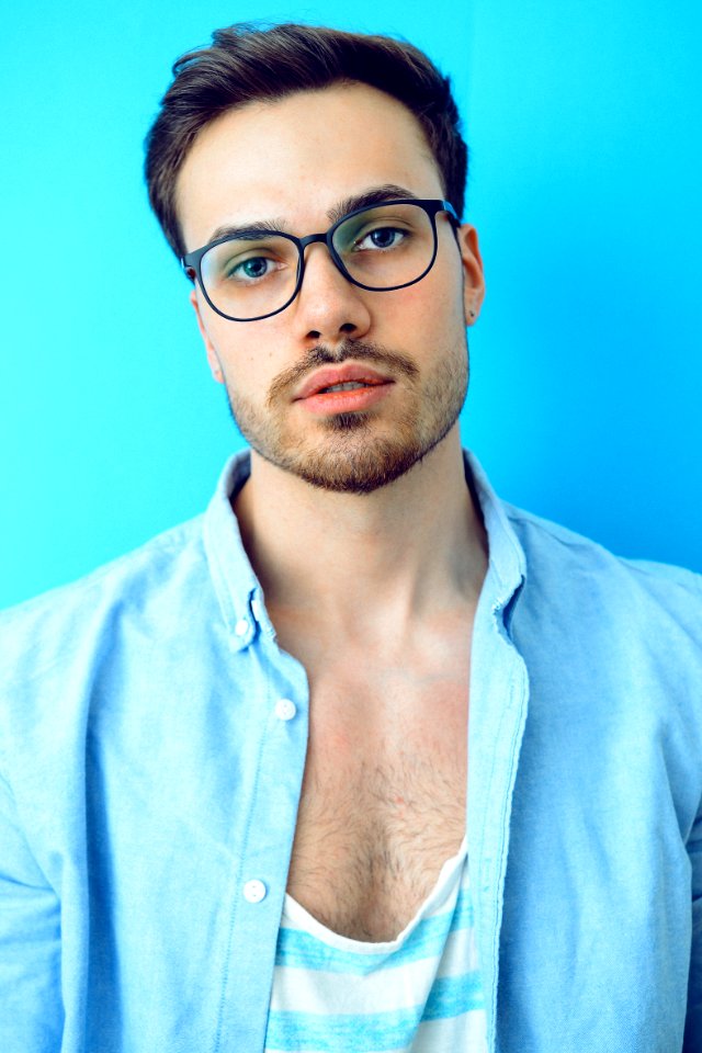 Man In Black Framed Eyeglasses And Blue Button-up Shirt