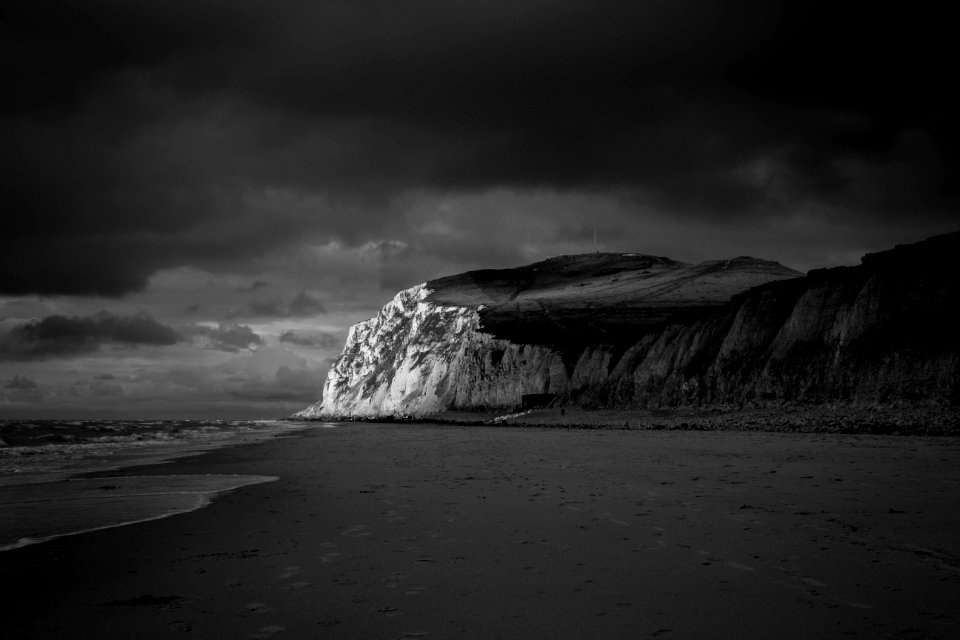 Mountain Near Beach Shore Under Dark Cloudy Sky photo