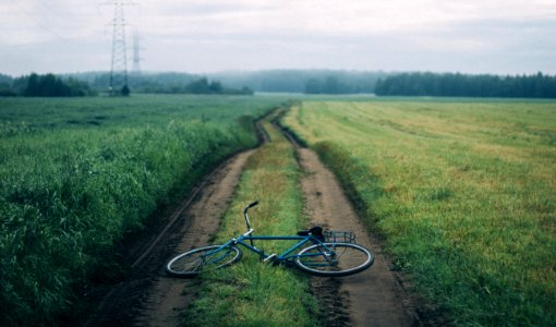 Landscape Photography Of Blue Commuter Bike On Green Grass