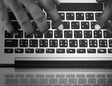 Persons Hand On Computer Keyboard photo
