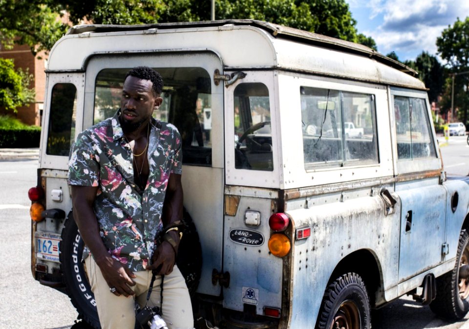 Man Stands Near White Land Rover Defender At Daytime