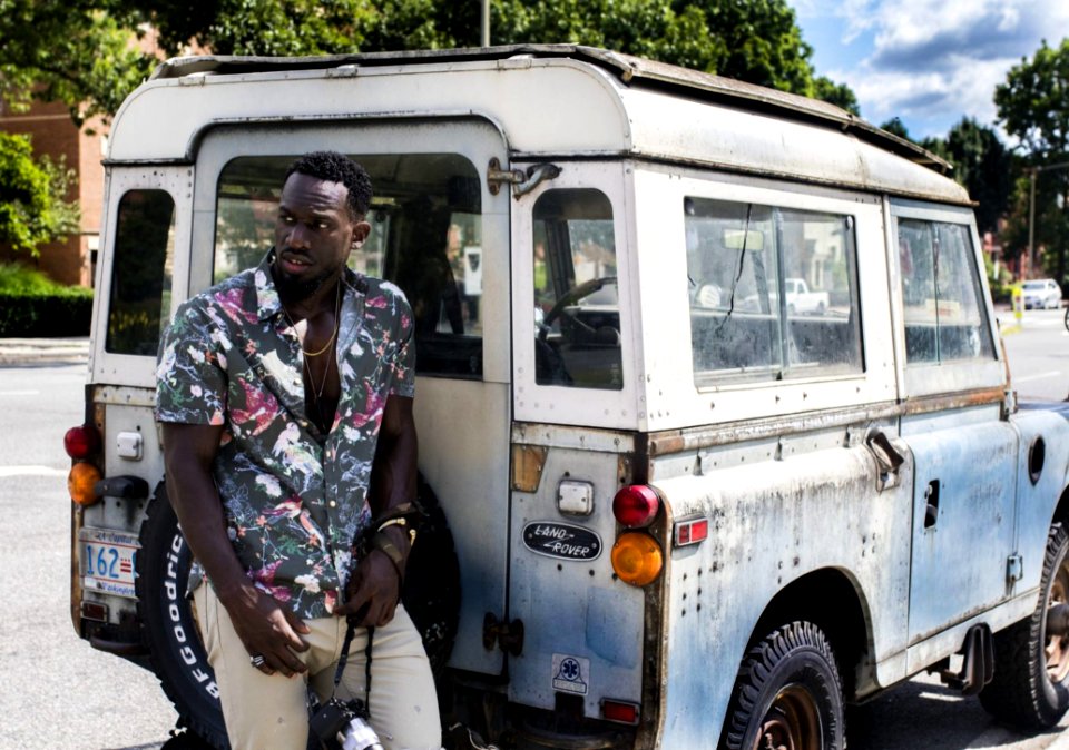 Man Stands Near White Land Rover Defender At Daytime photo