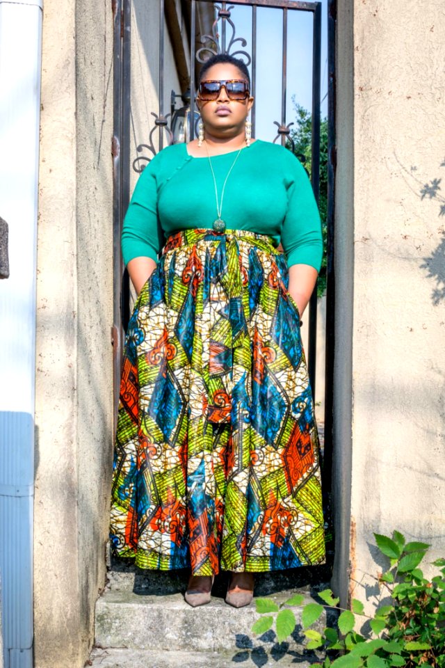 Woman Wearing Green Long-sleeved Shirt And Printed Skirt