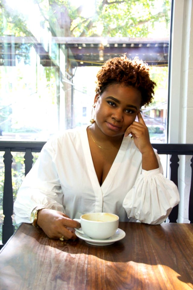 Woman Wearing White Deep V-neck Long-sleeved Blouse Holding White Ceramic Teacup