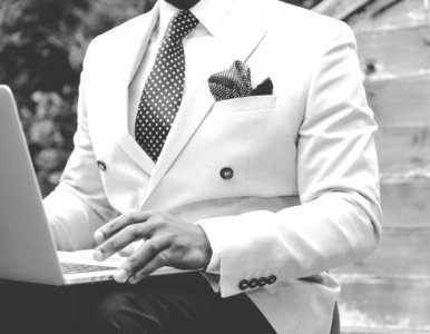 Grayscale Photo Of Man Wearing White Suit Jacket photo