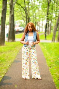 Woman In White Shirt With Denim Vest And Floral Pants