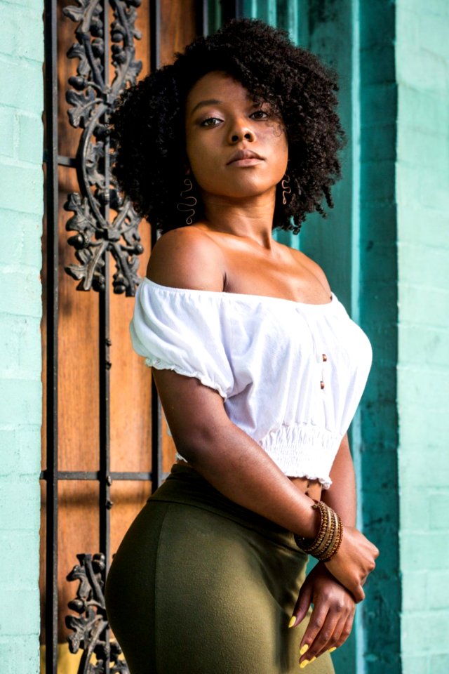 Woman Wearing White Off-shoulder Shirt And Green Bottoms photo