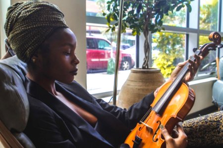 Woman Holding Violin By The Window photo